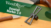 WoodRiver Dovetail Marker 2.0 tool with angled measurement scales on a workbench next to a carving knife handle