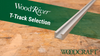 Aluminum WoodRiver T-track resting on a worn wooden workbench surface with Woodcraft logo.