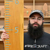 Woodcraft maker displays a finished wooden growth chart made with the WoodRiver template.