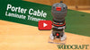 Porter-Cable laminate trimmer positioned on plywood with Woodcraft logo and play button overlay