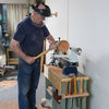 Woodworker using a gouge chisel on a lathe to shape a wooden bowl blank
